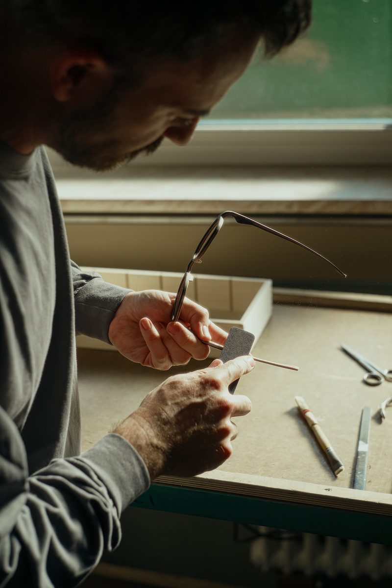 A Rolf craftsman shaping a frame by hand