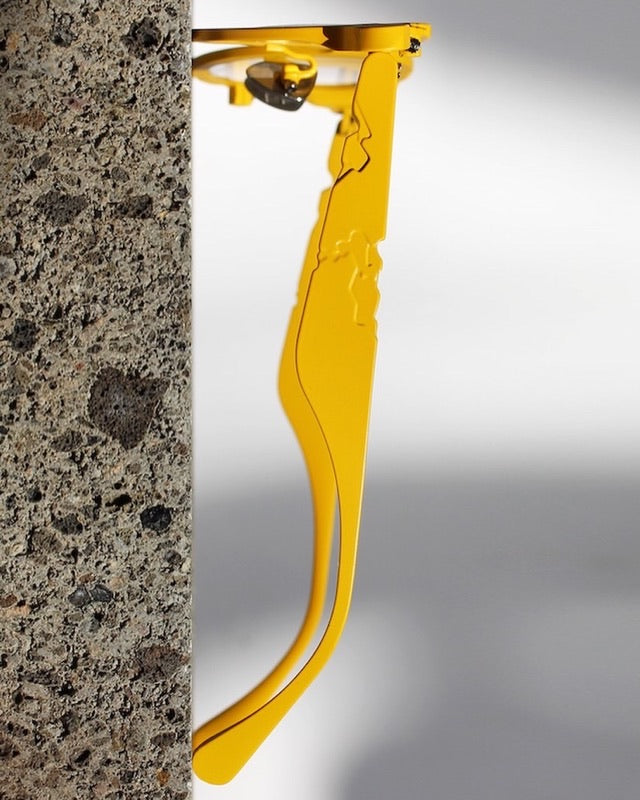 Titanium Museum frame in yellow, side view of the temple against stone