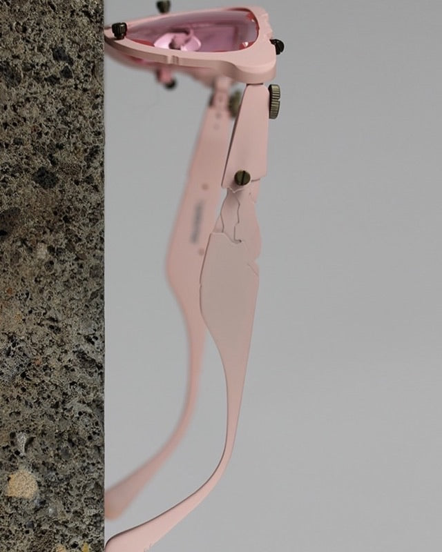 Titanium Museum frame in pink, side view of the temple against stone
